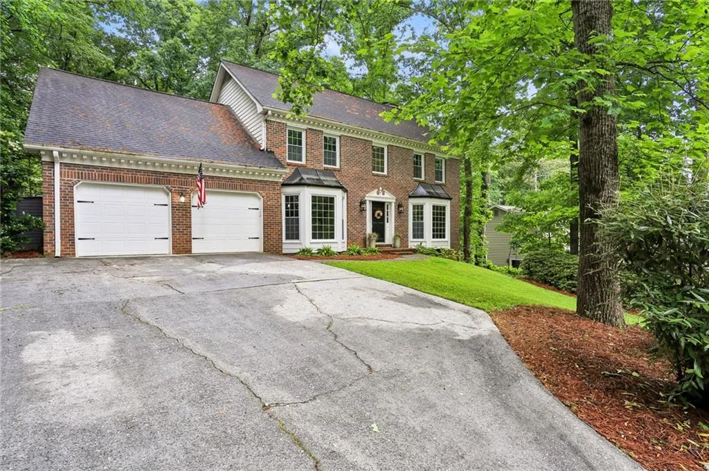 Colonial house with a garage and a front yard
