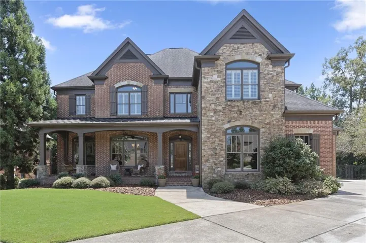 Brick and stone facade with dark shutters
