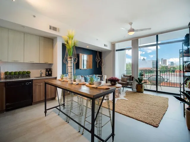 Full-height glass doors, balcony access, and a ceiling fan