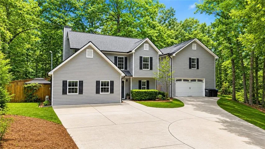 Two-story residence featuring gray siding and black shutters