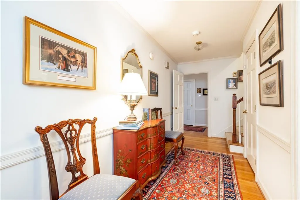 Hallway featuring ornamental molding