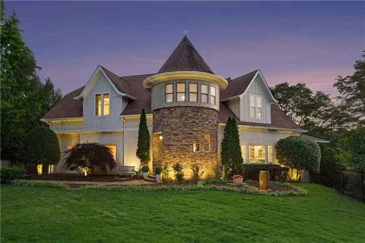 Distinctive architecture featuring a prominent stone turret with a conical roof and multi-pane windows