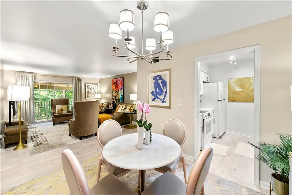 Dining room with light wood-style floors and a chandelier