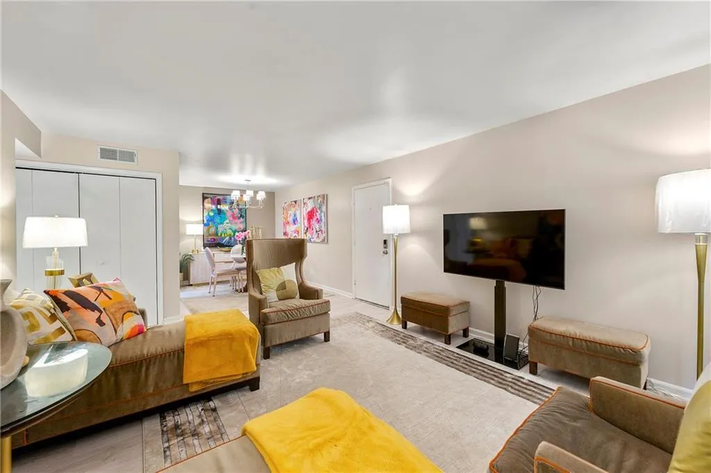 Living area with a chandelier and baseboards