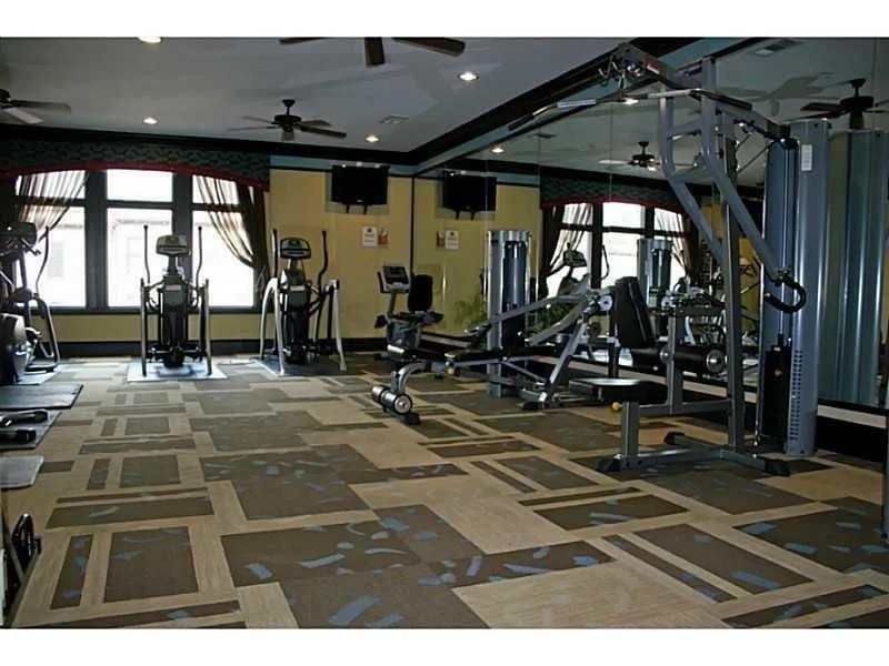 Gym featuring a ceiling fan and recessed lighting