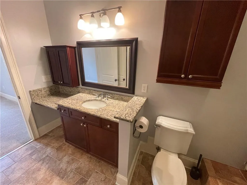 Bathroom featuring vanity and baseboards