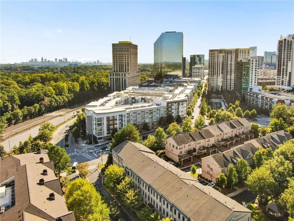 Urban residential setting featuring a mix of townhomes and multi-story apartment buildings