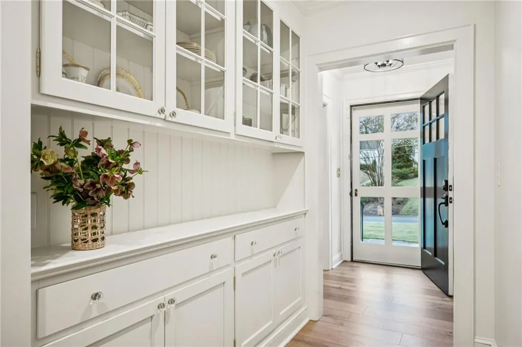 Doorway featuring hardwood / wood-style flooring and crown molding