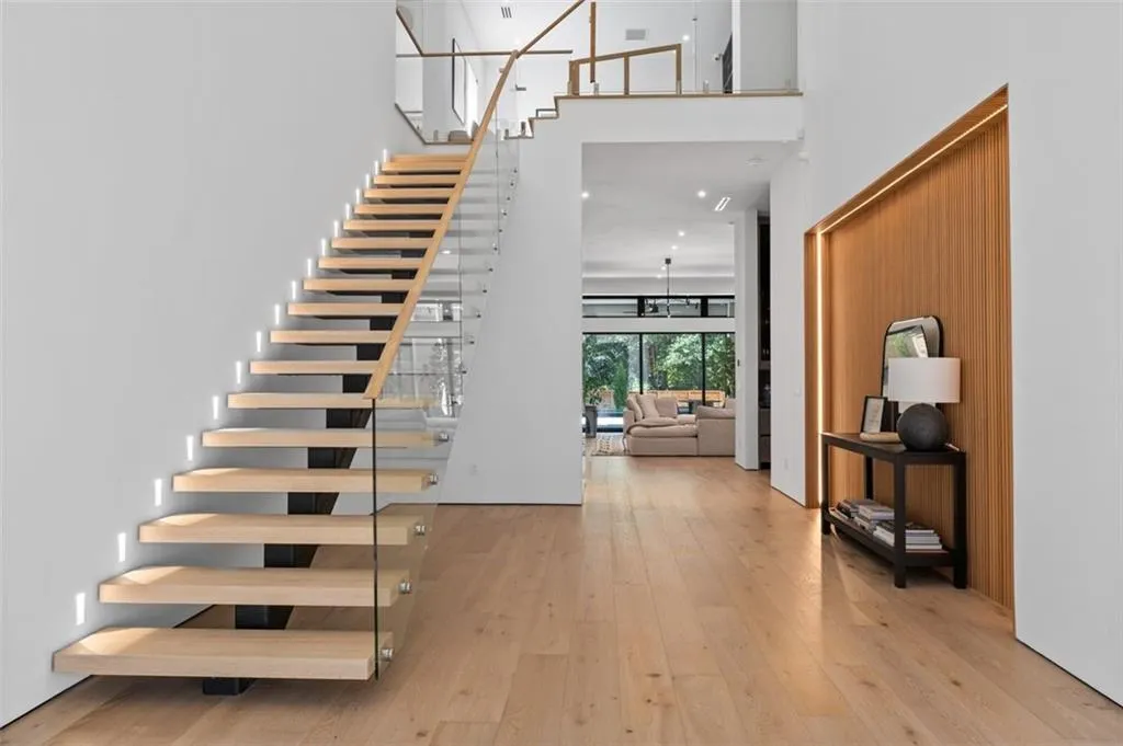 Grand, two-story entryway featuring white oak floor, floating staircase
