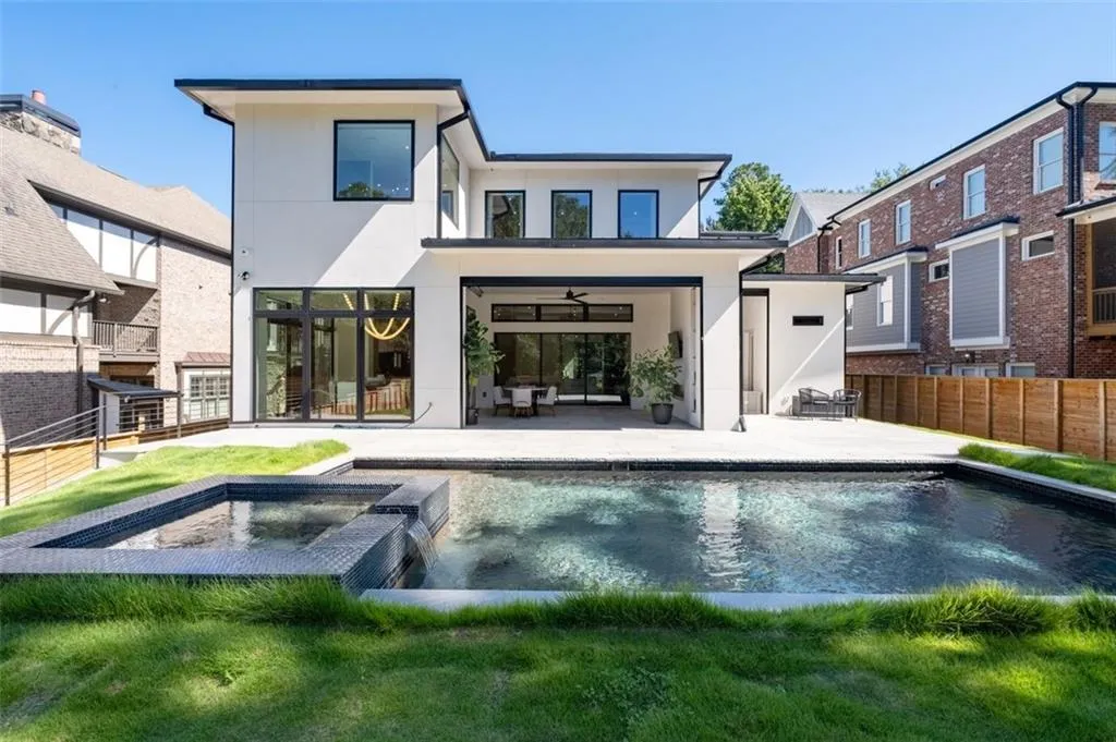 A stunning saltwater pool with an integrated hot tub, designed for both relaxation and recreation, creating a true backyard oasis.