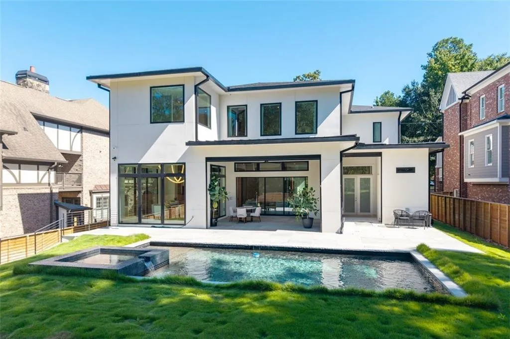 A stunning saltwater pool with an integrated hot tub, designed for both relaxation and recreation, creating a true backyard oasis.