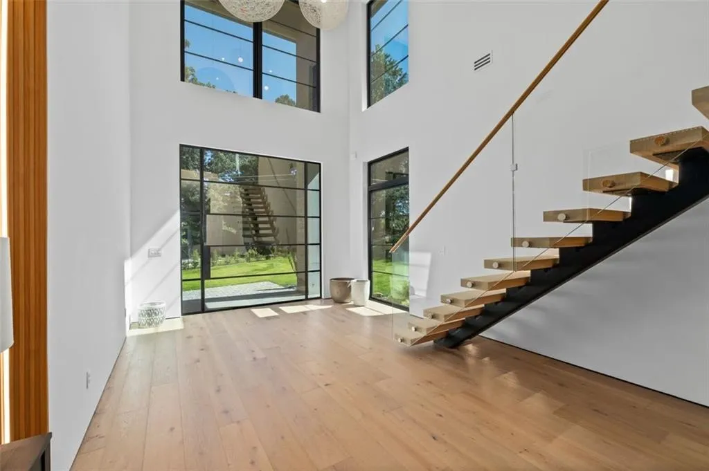 Grand, two-story entryway featuring white oak floor, floating staircase