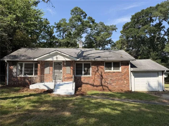 Brick exterior with a gabled roof and attached garage
