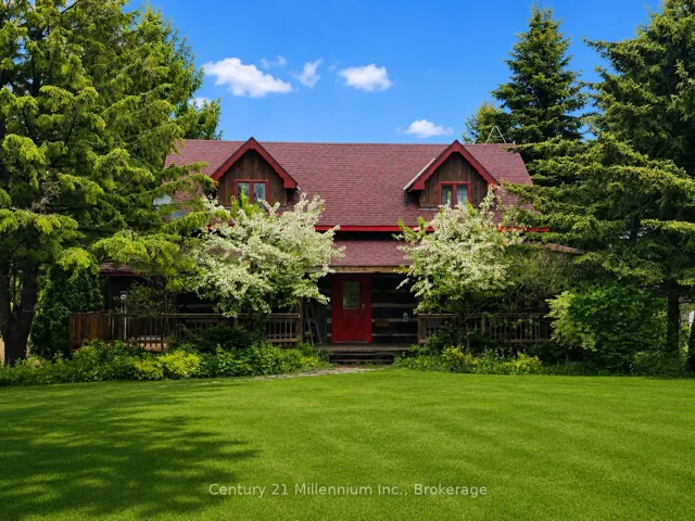 Modern Log Home.  Deck wraps around the house.