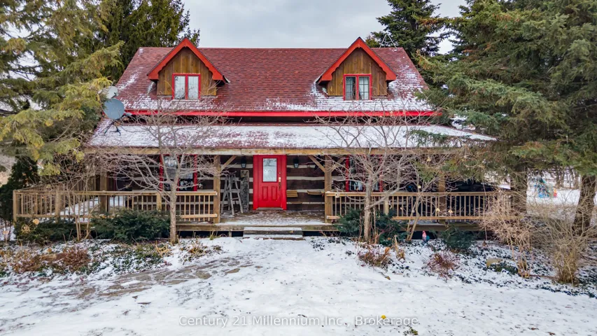 Modern Log Home.  Deck wraps around the house.