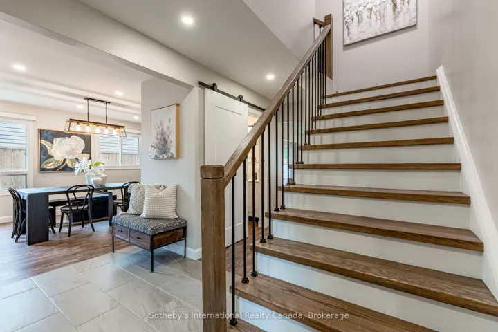 Red oak staircase accented by black iron railings.