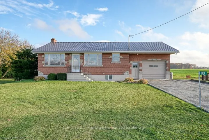 View of front of property with a garage and a front lawn