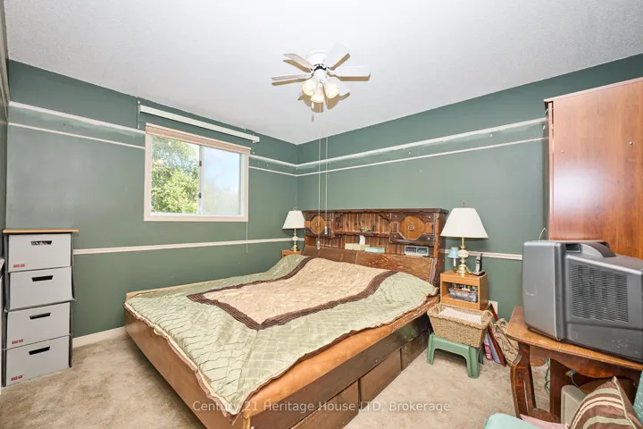 Upper level primary bedroom w window & ceiling fan