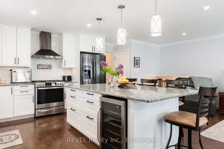 Main Floor kitchen with large island, wine fridge.