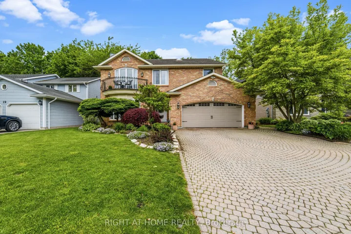 Front of House with large cobble stone driveway