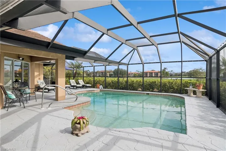 View of pool with a patio and a lanai