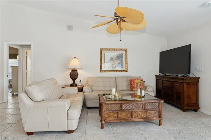 Family room featuring vaulted ceiling and ceiling fan