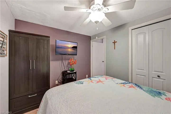 Bedroom featuring wood-type flooring, a closet, and ceiling fan