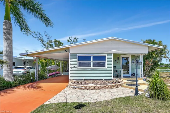 Manufactured / mobile home with a carport and a porch