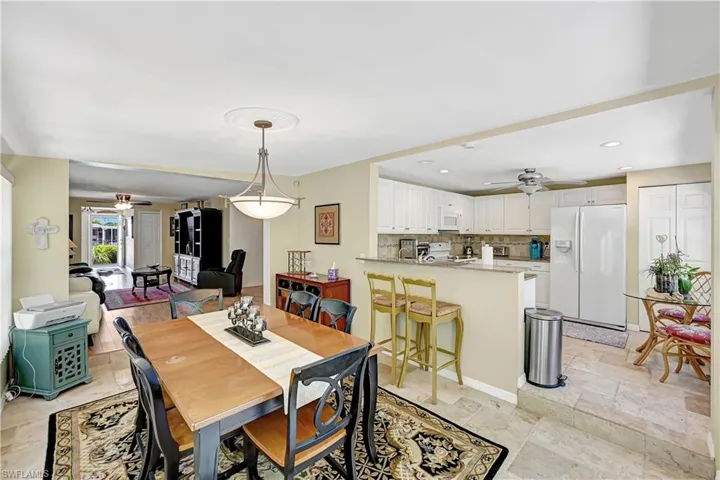 Tiled dining room featuring ceiling fan