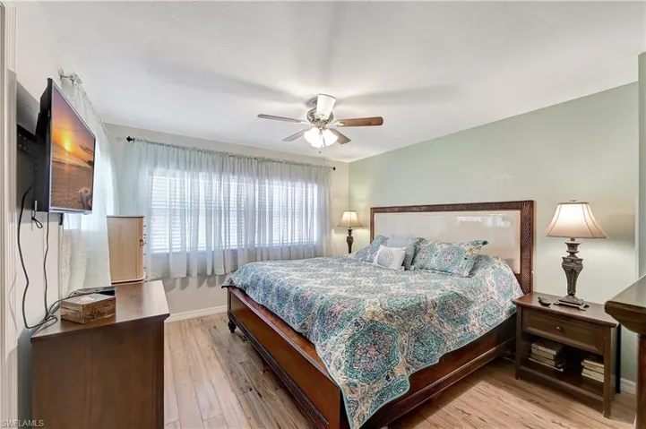 Bedroom with ceiling fan and light hardwood / wood-style floors