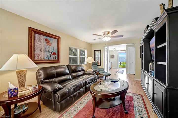 Living room featuring ceiling fan and light wood-type flooring
