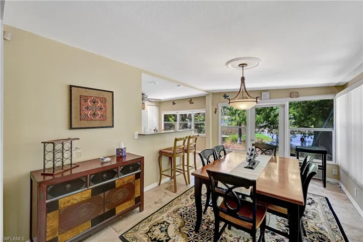 Dining room with ceiling fan and light tile flooring