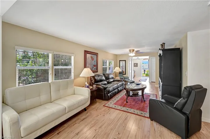 Living room featuring ceiling fan and light hardwood / wood-style flooring