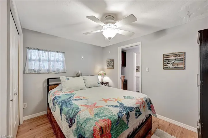 Bedroom with ceiling fan, a closet, and light hardwood / wood-style floors