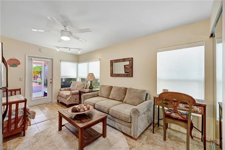 Tiled living room featuring track lighting and ceiling fan