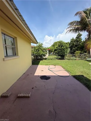 Patio area with concrete surface and expansive green space