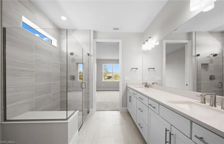 Bathroom with double vanity, a stall shower