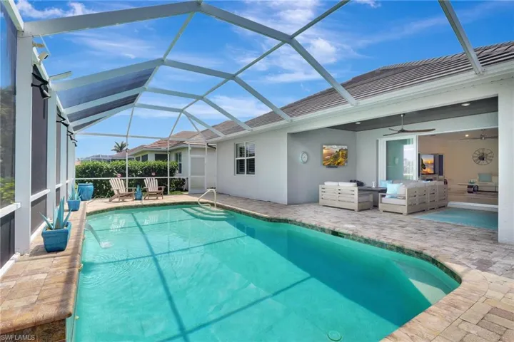 Pool featuring an outdoor hangout area, a ceiling fan, glass enclosure, and a patio
