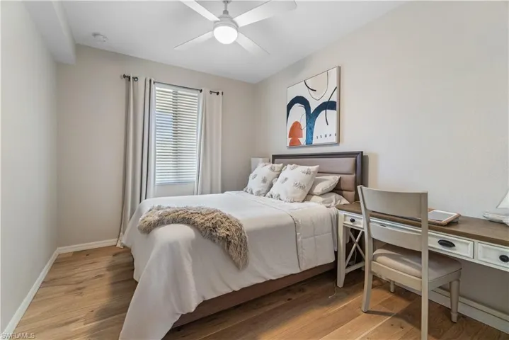 Bedroom with wood-type flooring and ceiling fan
