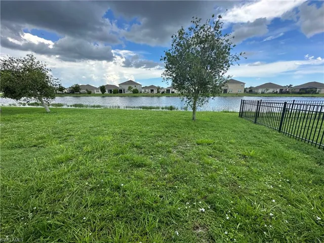 View of yard featuring a residential view and a water view