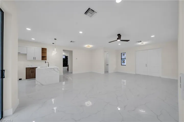 Unfurnished living room featuring recessed lighting and a ceiling fan