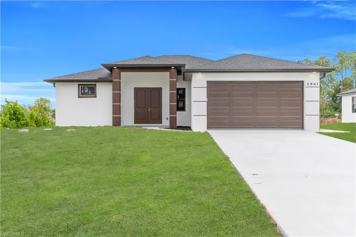 Prairie-style house with stucco siding, roof with shingles, a front yard, and concrete driveway