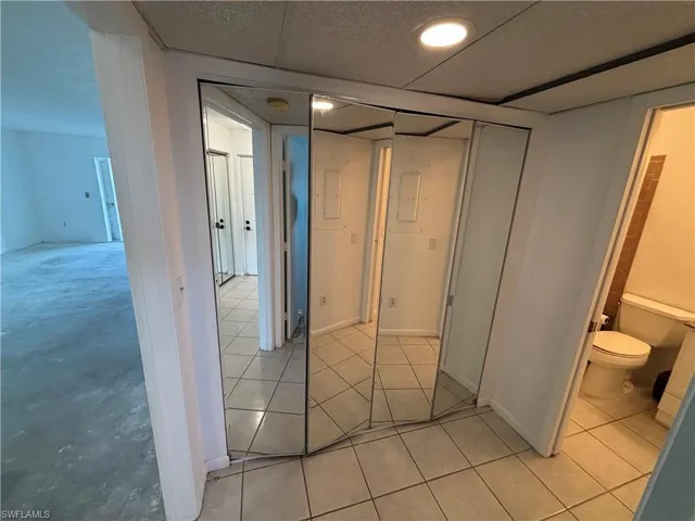 Hallway with light tile patterned floors