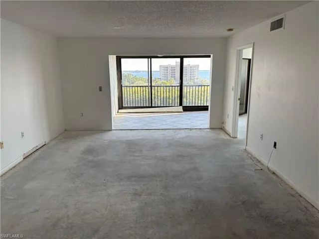 Empty room with a textured ceiling