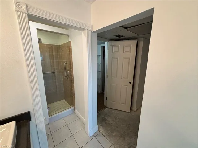 Bathroom with tile patterned flooring and an enclosed shower