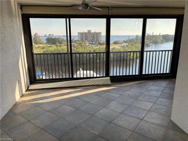 Unfurnished sunroom featuring a water view