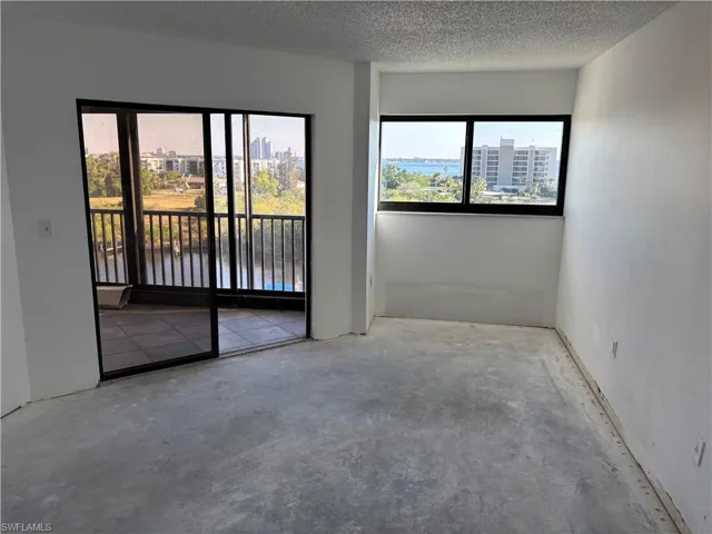 Empty room with concrete floors and a textured ceiling