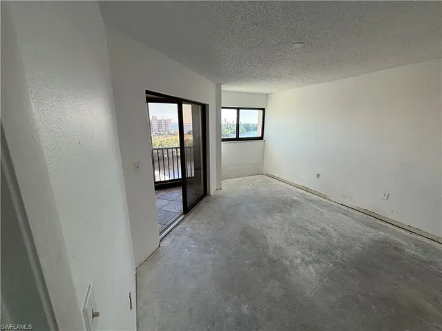 Unfurnished room featuring a textured ceiling