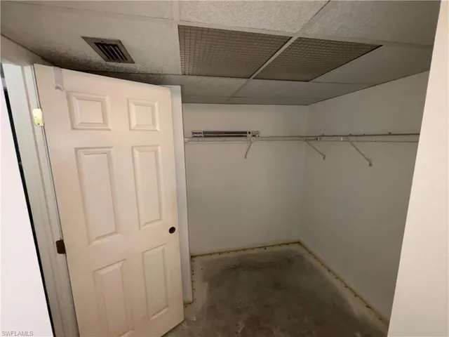Spacious closet with a paneled ceiling