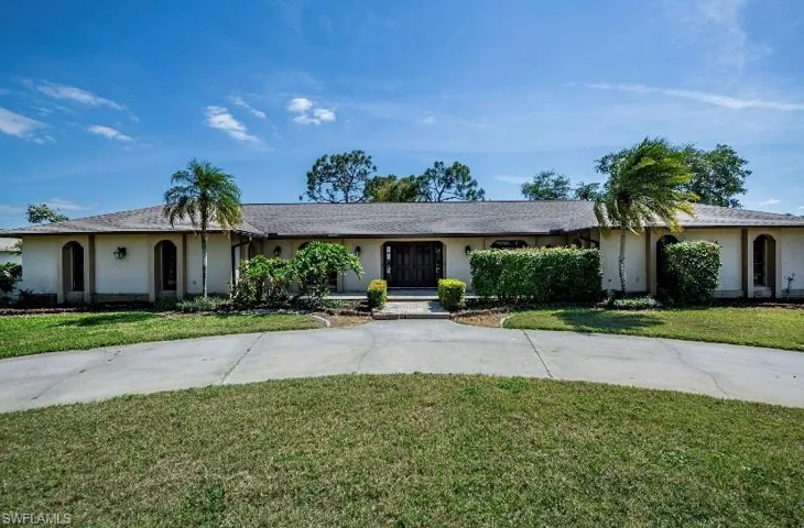 Single story home with a front lawn